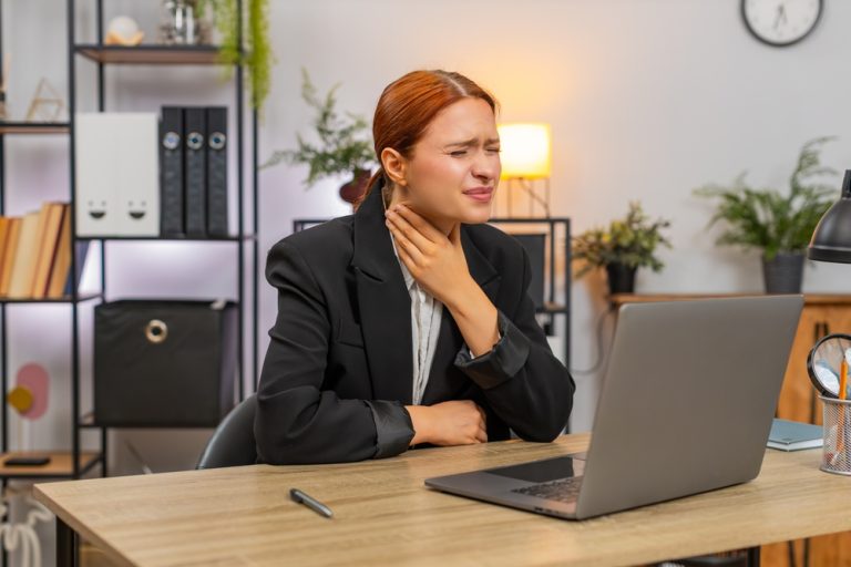 young,businesswoman,at,home,office,feels,pain,swallowing,during,laptop