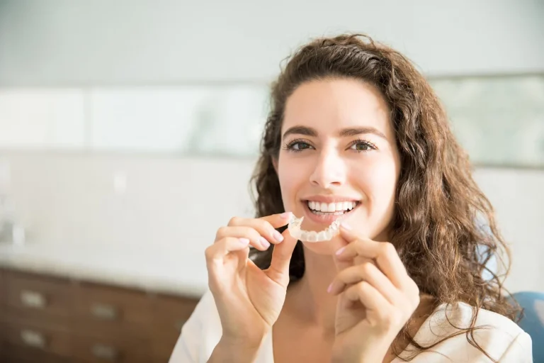 portrait beautiful patient holding orthodontic retainers dental clinic